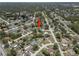 An aerial view of a neighborhood showcasing single Gathering homes and mature trees at 3529 Orion Rd, Spring Hill, FL 34606