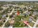 An aerial view shows a neighborhood featuring a mix of homes and mature trees at 3529 Orion Rd, Spring Hill, FL 34606