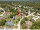 Aerial view of a residential area with numerous homes and verdant tree coverage at 3529 Orion Rd, Spring Hill, FL 34606