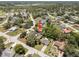 Aerial view of homes in a residential neighborhood with tree coverage and well-maintained streets at 3529 Orion Rd, Spring Hill, FL 34606