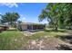 Spacious backyard with a screened-in patio and lush green lawn, ideal for outdoor activities at 3529 Orion Rd, Spring Hill, FL 34606