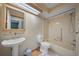 Clean, classic bathroom featuring a tub, toilet, and pedestal sink at 3529 Orion Rd, Spring Hill, FL 34606