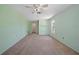 Comfortable bedroom featuring neutral carpeting, light green walls, and a large window at 3529 Orion Rd, Spring Hill, FL 34606