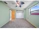 Comfortable bedroom with carpeting, a ceiling fan, and a closet for ample storage at 3529 Orion Rd, Spring Hill, FL 34606