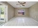 Bright bedroom features white tile floor, ceiling fan, and window offering ample natural light at 3529 Orion Rd, Spring Hill, FL 34606