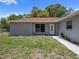 Close-up view of the front of the single-story home highlighting the front door and manicured lawn at 3529 Orion Rd, Spring Hill, FL 34606