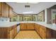 Functional kitchen featuring wood cabinetry, white countertops, and natural light at 3529 Orion Rd, Spring Hill, FL 34606