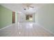 Bright and airy living room featuring tiled flooring, a ceiling fan, and large windows for plenty of natural light at 3529 Orion Rd, Spring Hill, FL 34606