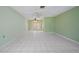 Spacious living room with tiled floors, ceiling fans, and glass doors leading to the backyard at 3529 Orion Rd, Spring Hill, FL 34606