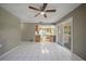 Open living area with bright tile floors, flowing into the kitchen and outdoor patio at 3529 Orion Rd, Spring Hill, FL 34606