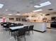 A spacious community room with tables, chairs, and a fully equipped kitchen at 3605 100Th N Ter, Pinellas Park, FL 33782