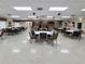 Spacious community room with tables, chairs, and stage area at 3605 100Th N Ter, Pinellas Park, FL 33782