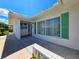 Inviting covered entry with modern window and stylish wall decoration, showcasing the home's curb appeal at 3605 100Th N Ter, Pinellas Park, FL 33782