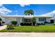 Charming single-story home with a well-manicured lawn, clean white exterior, and lush landscaping at 3605 100Th N Ter, Pinellas Park, FL 33782
