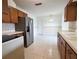 Traditional kitchen with stainless steel refrigerator and tile flooring at 3605 100Th N Ter, Pinellas Park, FL 33782