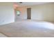 Spacious living room featuring neutral carpet, a mirrored accent wall, and an open layout at 3605 100Th N Ter, Pinellas Park, FL 33782