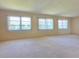 Spacious living room with ample natural light from large windows at 3605 100Th N Ter, Pinellas Park, FL 33782