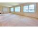 Expansive living room featuring large windows and neutral carpet at 3605 100Th N Ter, Pinellas Park, FL 33782