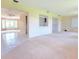 Open concept living room connects to dining area, showcasing tile and carpet flooring at 3605 100Th N Ter, Pinellas Park, FL 33782