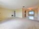 Open living space with tile and carpet flooring, featuring a chandelier and access to the kitchen at 3605 100Th N Ter, Pinellas Park, FL 33782