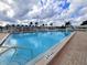 Outdoor community pool with clear blue water on a sunny day, surrounded by lounge chairs at 3605 100Th N Ter, Pinellas Park, FL 33782