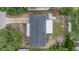 Aerial perspective of a property highlighting the home's layout, roof, backyard, and surrounding greenery at 3625 Oakhurst Dr, Holiday, FL 34691