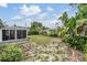 Lush backyard with garden beds, a birdbath, and lots of green space, creating a tranquil outdoor oasis at 3625 Oakhurst Dr, Holiday, FL 34691