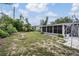 Expansive backyard with well-maintained lawn, lush trees, and a patio area, perfect for outdoor activities at 3625 Oakhurst Dr, Holiday, FL 34691