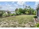 Spacious backyard with beautiful trees, lush landscaping, and room for gardening and outdoor entertainment at 3625 Oakhurst Dr, Holiday, FL 34691