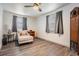 Serene bedroom with hardwood floors, natural light from windows, and a comfortable armchair at 3625 Oakhurst Dr, Holiday, FL 34691