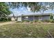 Inviting single-story home with a manicured front yard and gray exterior at 3625 Oakhurst Dr, Holiday, FL 34691
