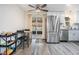 Bright kitchen with stainless steel fridge, hardwood flooring and a dining area near the sliding glass door at 3625 Oakhurst Dr, Holiday, FL 34691