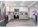 Open kitchen featuring stainless steel appliances, granite countertops, and a view to the living room at 3625 Oakhurst Dr, Holiday, FL 34691