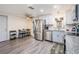 Modern kitchen with stainless steel appliances, white cabinets, and a dining area at 3625 Oakhurst Dr, Holiday, FL 34691