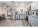 Modern kitchen featuring stainless steel appliances, gray cabinets and a sliding glass door to the patio at 3625 Oakhurst Dr, Holiday, FL 34691