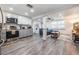 Open concept kitchen and living room with hardwood floors, stainless appliances, and modern finishes at 3625 Oakhurst Dr, Holiday, FL 34691