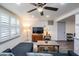 Cozy living room with a comfy couch, ceiling fan and natural light from the window at 3625 Oakhurst Dr, Holiday, FL 34691