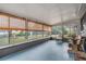 Inviting sunroom featuring large windows with bamboo shades, offering serene backyard views and natural light at 3625 Oakhurst Dr, Holiday, FL 34691