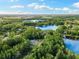 Breathtaking aerial view of the house, nestled amidst lush greenery, showcasing the surrounding lakes and landscape at 3663 Berger Rd, Lutz, FL 33548
