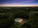 Stunning aerial view of the property showcasing the pool, lush greenery, and the home's prime location at 3663 Berger Rd, Lutz, FL 33548
