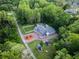 Property aerial shot featuring a meticulously landscaped yard, private pool, and complemented by lush greenery at 3663 Berger Rd, Lutz, FL 33548