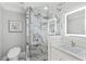 Modern bathroom featuring marble shower, sleek vanity, and illuminated mirror at 3663 Berger Rd, Lutz, FL 33548