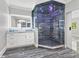 Modern bathroom features blue granite countertops, large glass walk-in shower with rain head, and a vessel sink at 3663 Berger Rd, Lutz, FL 33548