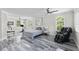 Large bedroom with seating area, modern fan and a beautiful view from every window at 3663 Berger Rd, Lutz, FL 33548