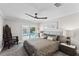 This bedroom boasts a comfy bed, modern ceiling fan, and sliding doors to the pool at 3663 Berger Rd, Lutz, FL 33548