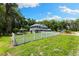Sprawling two-story home with white picket fence and lush lawn, exuding curb appeal and country charm at 3663 Berger Rd, Lutz, FL 33548