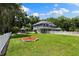 Expansive two-story home with a charming exterior, lush green lawn, and complemented by a white picket fence at 3663 Berger Rd, Lutz, FL 33548