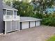 Three-car garage adjacent to home with ample parking on pea gravel driveway at 3663 Berger Rd, Lutz, FL 33548