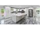 Bright, modern kitchen with marble countertops, stainless steel appliances, and tile flooring at 3663 Berger Rd, Lutz, FL 33548