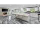 Open concept kitchen with island and bar stool seating adjacent to a fireplace at 3663 Berger Rd, Lutz, FL 33548